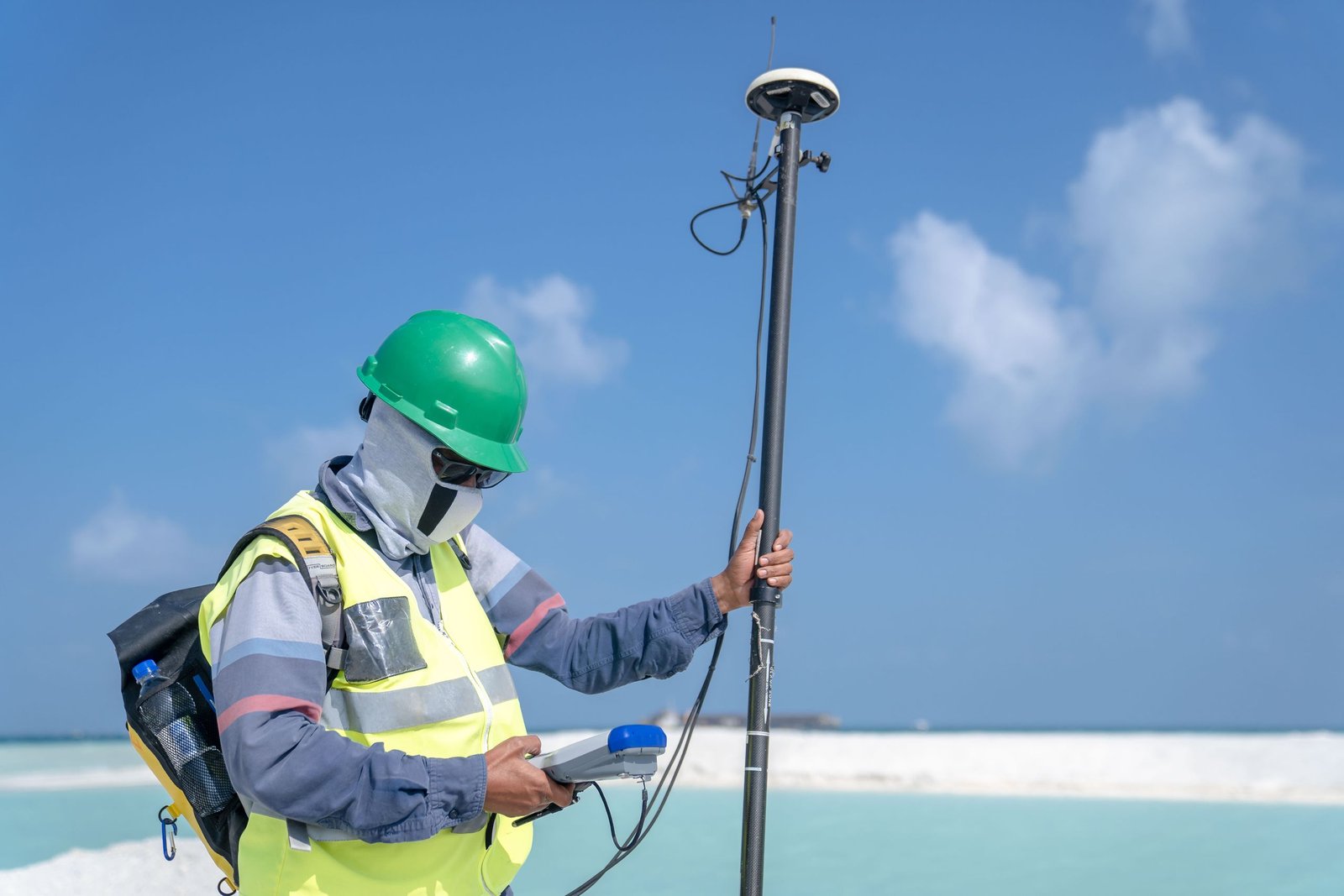 Surveyor using GNSS RTK rover for precise land measurement — AZGPS Network 2026